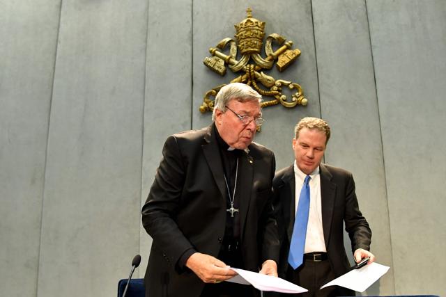 Australian Cardinal George Pell (left), flanked by Vatican press office director Greg Burke, leaves after his statement at the Holy See Press Office in Vatican City, on June 29, 2017. (AFP)