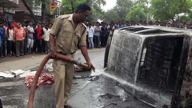 Pictures circulating on social media showed people hitting the man, meat pieces strewn on the road, and his car in flames. (HT photo) Pictures circulating on social media showed people hitting the man, meat pieces strewn on the road, and his car in flames. (HT photo)