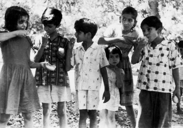 (From right) The Hashmi children: Safdar, Sabiha, Shabnam, cousin Zoobi, Sohail, and Shehla, all tucking in except for Shabnam, who seems bothered by the heat. (Photo: Sohail Hashmi) (From right) The Hashmi children: Safdar, Sabiha, Shabnam, cousin Zoobi, Sohail, and Shehla, all tucking in except for Shabnam, who seems bothered by the heat. (Photo: Sohail Hashmi)