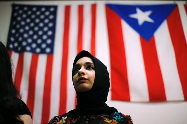 A woman attends a town hall meeting following a rally to protest restrictive guidelines issued by the US on who qualifies as a close familial relationship under the Supreme Court order on the Muslim and refugee ban at Union Square on June 29, 2017, in New York. (AFP) A woman attends a town hall meeting following a rally to protest restrictive guidelines issued by the US on who qualifies as a close familial relationship under the Supreme Court order on the Muslim and refugee ban at Union Square on June 29, 2017, in New York. (AFP)