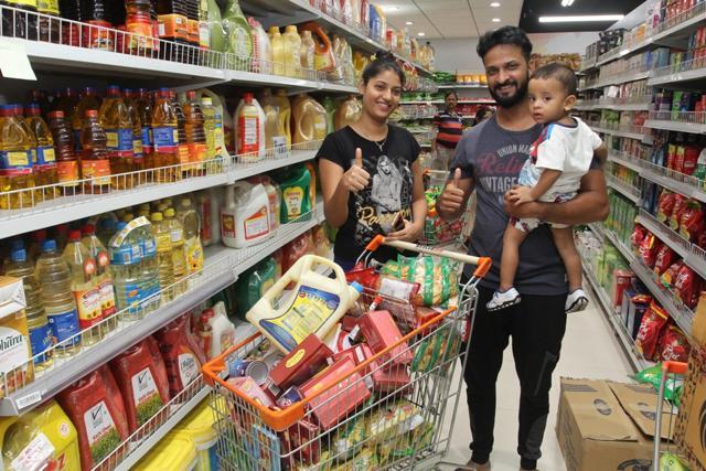 Families take advantage of the midnight discount offered by supermarkets to stock up on groceries. (Praful Gangurde)