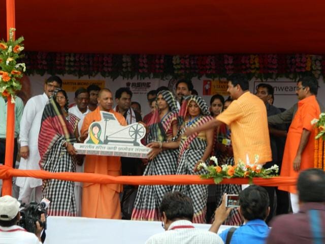 Yogi Adityanath distributes solar-opearated spinning wheels at Kakrahia village. (HT Photo)