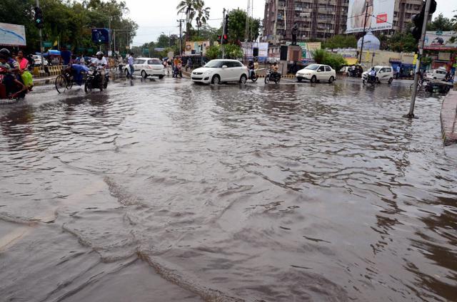 Patna: Vehicles ply at waterlogged road after heavy rains in Patna on July 2, 2017.  (PTI)