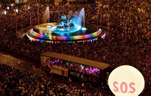 People gather at the Cibeles square to watch participants on floats during the WorldPride 2017 parade in Madrid on July 1, 2017. (AFP) People gather at the Cibeles square to watch participants on floats during the WorldPride 2017 parade in Madrid on July 1, 2017. (AFP)