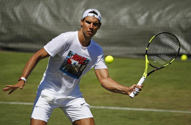 Spain's Rafael Nadal volleys the ball during a practice session ahead of the Wimbledon Tennis Championship. (AP)