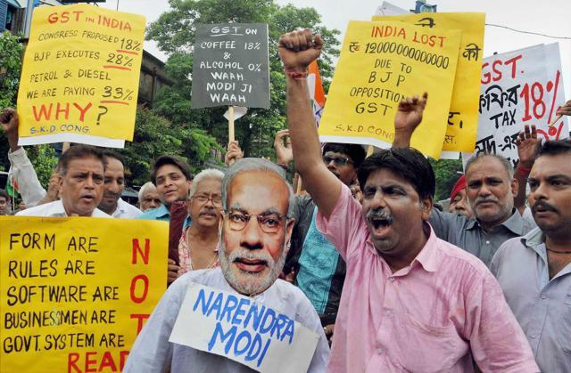 Congress activists protest against Prime Minister Narendra Modi for implementation of GST, in Kolkata. (PTI Photo)