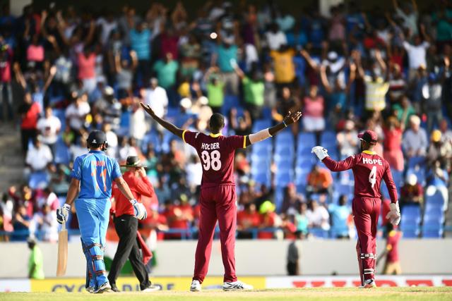 West Indies captain Jason Holder (#98) celebrates their win at the end of the fourth One Day International (ODI) match against India. (AFP)