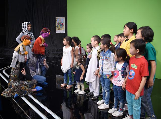 The muppets being introduced to children after a recording at a television studio in Kabul. (AFP)