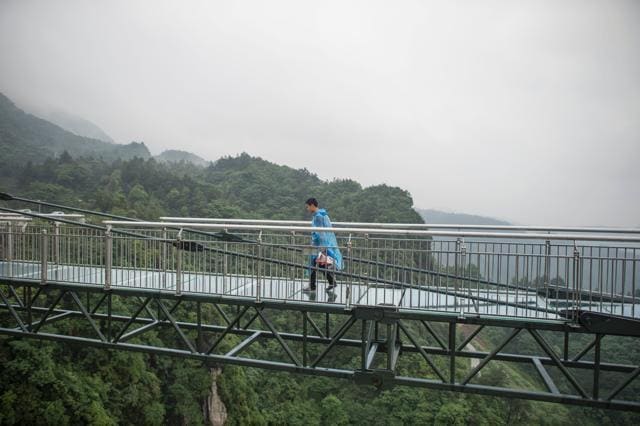 The v-shaped walkway stretches almost 70 metres from a sheer cliff face in southwest Chongqing. (AFP/Fred Dufour)