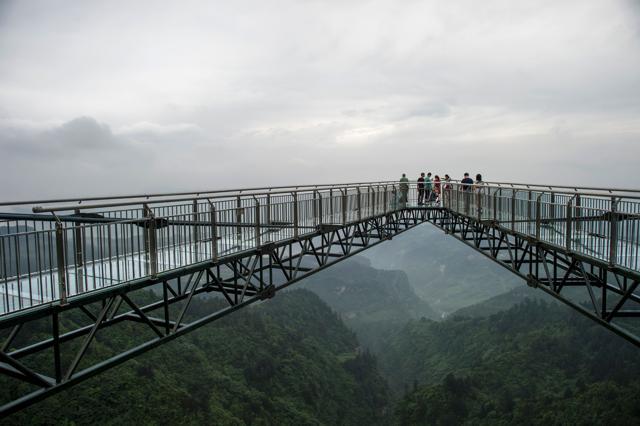 Similar glass-bottomed constructions have become popular attractions at scenic parks in China. (AFP/Fred Dufour)