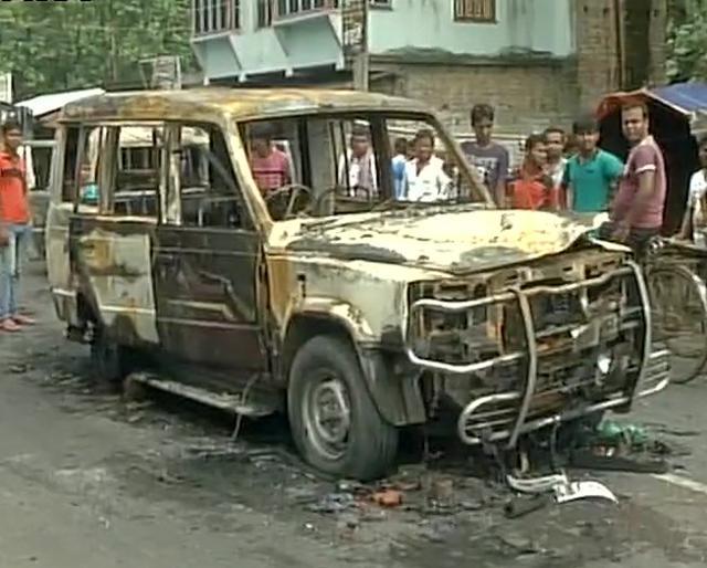 A mob allegedly set shops and houses on fire and burnt police vehicles to protest against the post. (ANI Twitter) A mob allegedly set shops and houses on fire and burnt police vehicles to protest against the post. (ANI Twitter)