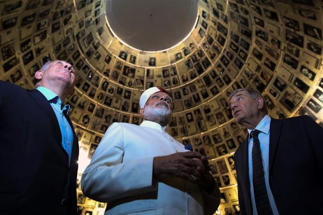 Indian Prime Minister Narendra Modi (C) and Israel's Prime Minister Benjamin Netanyahu (L) look at pictures of Jewish Holocaust victims at the Hall of Names during his visit to the Yad Vashem Holocaust Memorial museum commemorating the six million Jews killed by the Nazis during World War II. (Dan Balilty / AFP) Indian Prime Minister Narendra Modi (C) and Israel's Prime Minister Benjamin Netanyahu (L) look at pictures of Jewish Holocaust victims at the Hall of Names during his visit to the Yad Vashem Holocaust Memorial museum commemorating the six million Jews killed by the Nazis during World War II. (Dan Balilty / AFP)