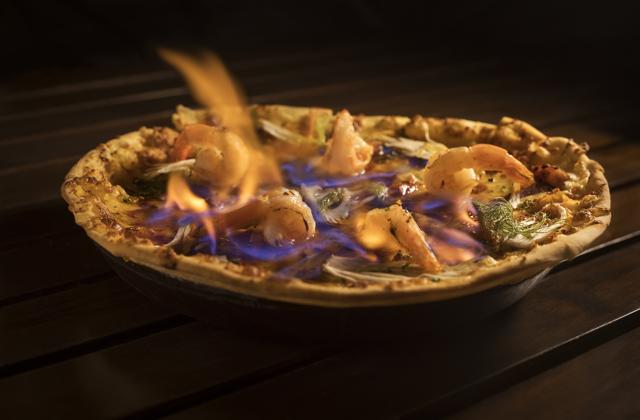 “We pour rum on the pizza and set it on fire. Although none of the alcohol remains, the flavor does adds a little special something to the taste,” says executive chef Zubin D’Souza. (Pizza by the Bay) “We pour rum on the pizza and set it on fire. Although none of the alcohol remains, the flavor does adds a little special something to the taste,” says executive chef Zubin D’Souza. (Pizza by the Bay)