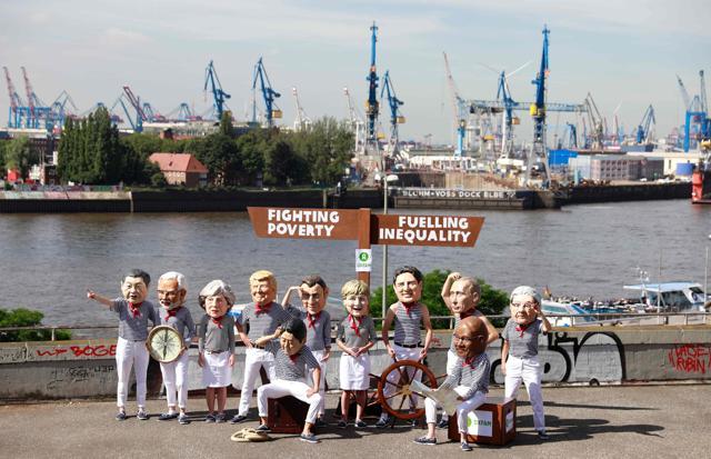 Anti-capitalism activists wearing masks featuring (L-R) China's President Xi Jinping, India's Prime Minister Narendra Modi, Britain's Prime Minister Theresa May, US President Donald Trump, Japan's Prime Minister Shinzo Abe (sitting), French President Emmanuel Macron, German chancellor Angela Merkel, Canada's Prime Minister Justin Trudeau, Russia's President Vladimir Putin, South Africa's President Jacob Zuma (sitting) and Italy's Prime Minister Paolo Gentiloni during a protest on in Hamburg. (AFP Photo) Anti-capitalism activists wearing masks featuring (L-R) China's President Xi Jinping, India's Prime Minister Narendra Modi, Britain's Prime Minister Theresa May, US President Donald Trump, Japan's Prime Minister Shinzo Abe (sitting), French President Emmanuel Macron, German chancellor Angela Merkel, Canada's Prime Minister Justin Trudeau, Russia's President Vladimir Putin, South Africa's President Jacob Zuma (sitting) and Italy's Prime Minister Paolo Gentiloni during a protest on in Hamburg. (AFP Photo)