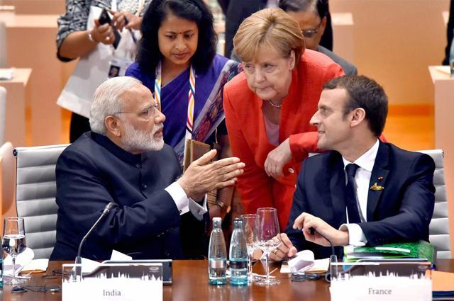 Prime Minister Narendra Modi interacts with German Chancellor Angela Merkel and French President Emmanuel Macron at the G-20 Summit in Hamburg, on July 7, 2016. (PTI) Prime Minister Narendra Modi interacts with German Chancellor Angela Merkel and French President Emmanuel Macron at the G-20 Summit in Hamburg, on July 7, 2016. (PTI)