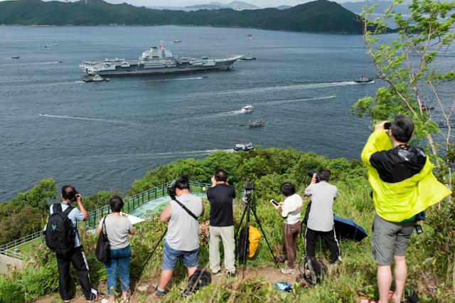 Hong Kong residents take photos as China's aircraft carrier Liaoning arrives in Hong Kong on July 7, 2017. (AFP) Hong Kong residents take photos as China's aircraft carrier Liaoning arrives in Hong Kong on July 7, 2017. (AFP)