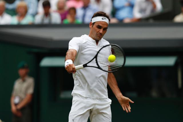 Switzerland's Roger Federer returns against Serbia's Dusan Lajovic during their men's singles second round match. (AFP)