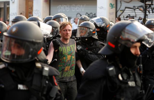 A man is detained by riot police in Hamburg on Saturday. (AFP) A man is detained by riot police in Hamburg on Saturday. (AFP)