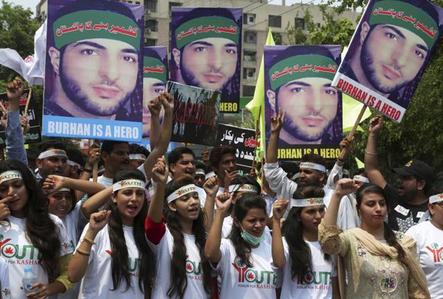 Members of a non-governmental organisation Youth Forum for Kashmir hold posters of Burhan Wani while chanting anti-Indian slogans during a rally in Lahore, Pakistan, on Saturday. (AP Photo)