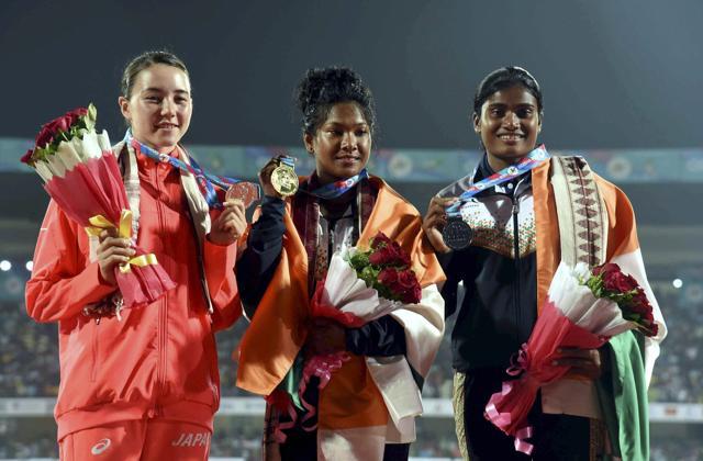 Heptathlon gold medallist Swapna Barman of India (C), Meg Hemphill of Japan (Silver) and India's Purnima Hembram (R) with bronze medal during the medal ceremony. (PTI)
