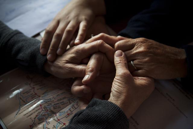 Elizabeth Brenner (L), and her family go through an emotional moment at a cafe in Munsiyari, Uttarakhand. They were finalizing the path they would take to hike to the spot where her son, Thomas Plotkin had a fatal fall in 2011. Under their hands is a local map that details the Milam Glacier Trail, the same trail that Plotkin was hiking on. (Rishabh R. Jain / AP) Elizabeth Brenner (L), and her family go through an emotional moment at a cafe in Munsiyari, Uttarakhand. They were finalizing the path they would take to hike to the spot where her son, Thomas Plotkin had a fatal fall in 2011. Under their hands is a local map that details the Milam Glacier Trail, the same trail that Plotkin was hiking on. (Rishabh R. Jain / AP)