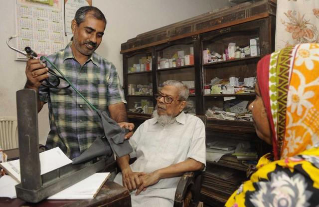 Compounder Debprasad Bairagi (left) and Dr Kaseed Ali, who have been working together in Basirhat for 35 years have been spreading the message for harmony to the patients coming for consultation. (Samir Jana)