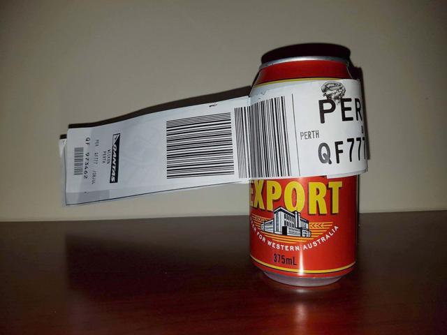 The can of beer with its baggage tag attached at the Perth Airport. (AFP Photo)
