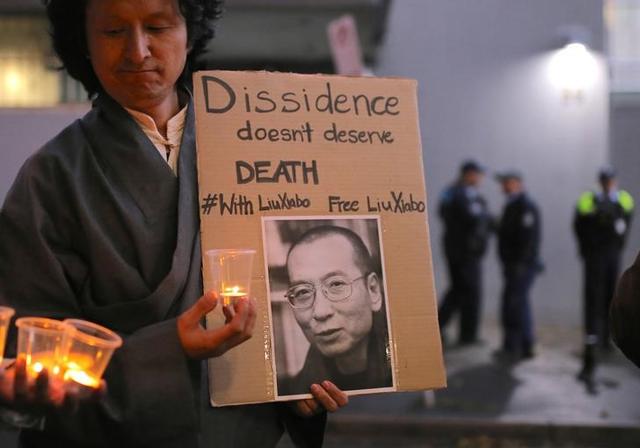 A member of the Australian Tibetan community holds a placard during a candlelight vigil for the Chinese Nobel Peace Prize-winning dissident Liu Xiaobo outside the Chinese consulate in Sydney on July 12, 2017. (Reuters) A member of the Australian Tibetan community holds a placard during a candlelight vigil for the Chinese Nobel Peace Prize-winning dissident Liu Xiaobo outside the Chinese consulate in Sydney on July 12, 2017. (Reuters)
