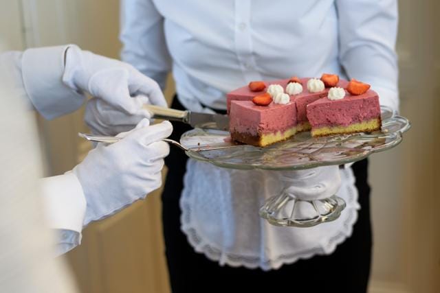 Women learn how to serve a dessert during a lesson. (AFP) Women learn how to serve a dessert during a lesson. (AFP)