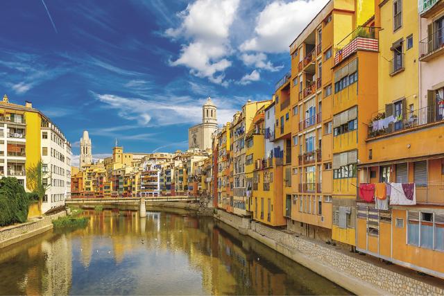 The reflection of vibrant narrow art deco houses and the red Eiffel Bridge in the water of river Onyar in Girona, Spain, makes a picture-perfect sight (Shutterstock) The reflection of vibrant narrow art deco houses and the red Eiffel Bridge in the water of river Onyar in Girona, Spain, makes a picture-perfect sight (Shutterstock)