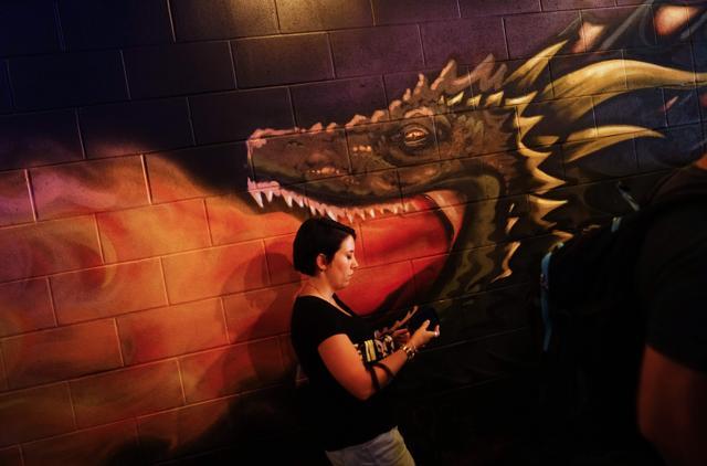 A woman walks past a mural of a dragon inside the bar in Washington. (Mandel Ngan/AFP) A woman walks past a mural of a dragon inside the bar in Washington. (Mandel Ngan/AFP)