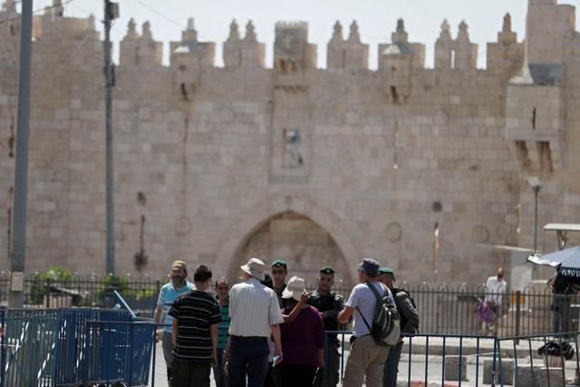 Israeli policemen stand guard outside Damascus Gate, a main entrance to Jerusalem's Old City, on July 15, 2017, after an attack that killed two police officers. (AFP)