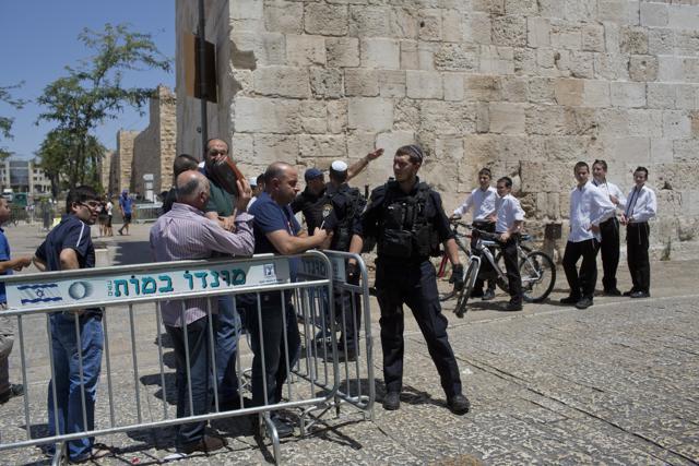 Palestinian Muslim worshippers prevented from entering Al-Aqsa Mosque for Friday prayers at Jaffa Gate outside Jerusalem's Old City on July 14, 2017. Israel's police chief said two officers were killed in an attack by Palestinians near a major Jerusalem shrine. (AP)
