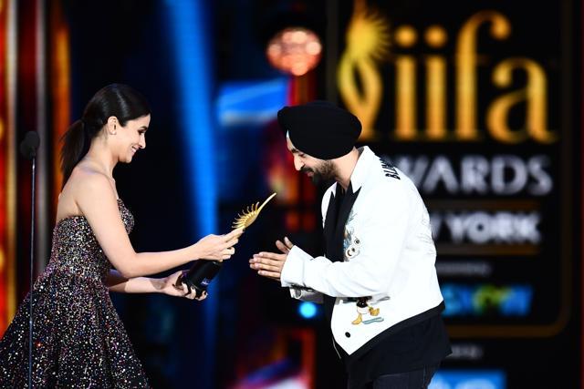 Diljit Dosanjh (R) accepts Best Debut actor award from actor Alia Bhatt during the 18th International Indian Film Academy (IIFA) Festival. (AFP) Diljit Dosanjh (R) accepts Best Debut actor award from actor Alia Bhatt during the 18th International Indian Film Academy (IIFA) Festival. (AFP)