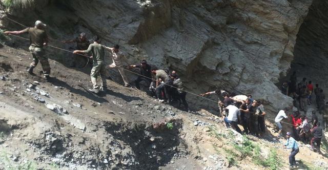 Police personnel and locals carry injured and dead from the site of a bus accident in Ramban district, about 140km from Jammu. (AFP) Police personnel and locals carry injured and dead from the site of a bus accident in Ramban district, about 140km from Jammu. (AFP)