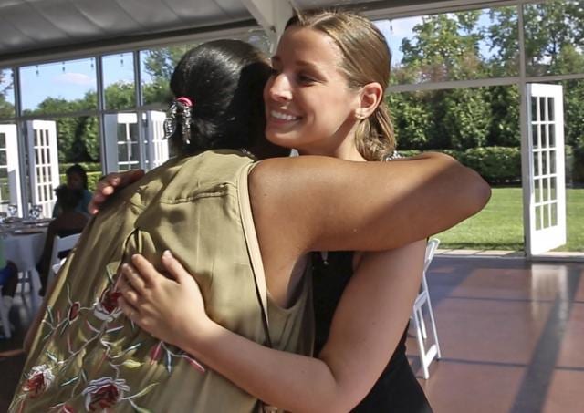 Janice Williamson-Cox, from Dayspring, left, hugs Sarah Cummins as she and others arrive at the Ritz Charles to enjoy a reception.  (AP Photo)