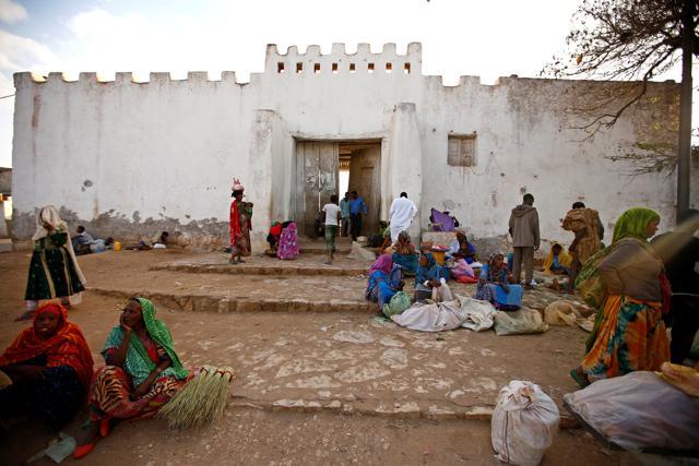 People sit outside the walled city of Harar, Ethiopia. The work undertaken by Abbas’s family has made brought about a change in the behaviour of the wild hyenas, making the city safer, and cleaner once night falls. (Tiksa Negeri / REUTERS) People sit outside the walled city of Harar, Ethiopia. The work undertaken by Abbas’s family has made brought about a change in the behaviour of the wild hyenas, making the city safer, and cleaner once night falls. (Tiksa Negeri / REUTERS)