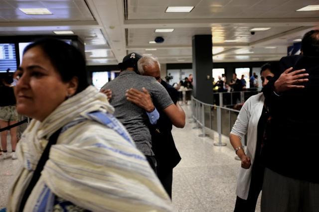 International passengers embrace family members as they arrive at Washington Dulles International Airport after the Trump administration's travel ban was allowed back into effect pending further judicial review on June 29, 2017. (Reuters) International passengers embrace family members as they arrive at Washington Dulles International Airport after the Trump administration's travel ban was allowed back into effect pending further judicial review on June 29, 2017. (Reuters)