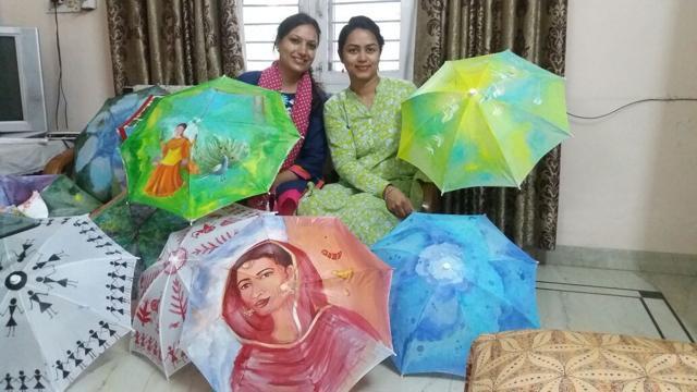 Artists showcase some of the painted umbrellas.