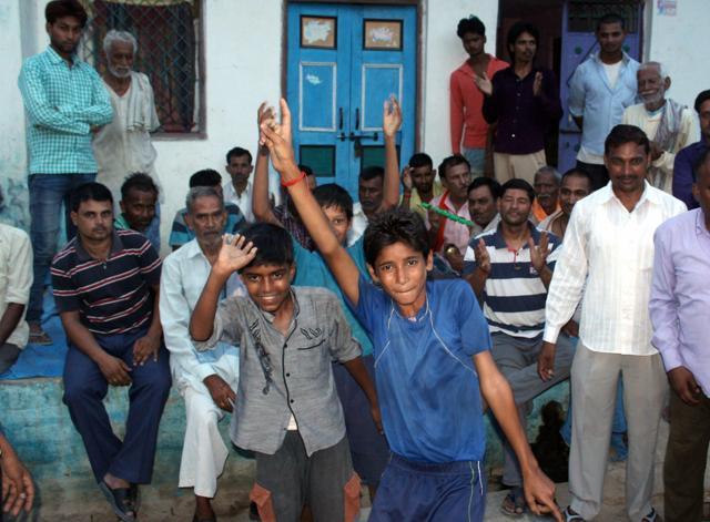 People celebrate after Bihar Governor Ram Nath Kovind was announced as NDA's presidential nominee at his village Paraunkhdera Pur in Kanpur Dehat. (PTI) People celebrate after Bihar Governor Ram Nath Kovind was announced as NDA's presidential nominee at his village Paraunkhdera Pur in Kanpur Dehat. (PTI)