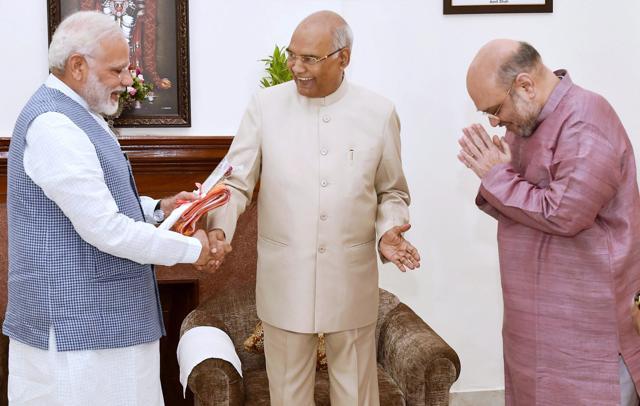 Prime Minister Narendra Modi with BJP President Amit Shah congratulates Ram Nath Kovind on being elected as the 14th President of India, in New Delhi on Thursday.  (PTI)