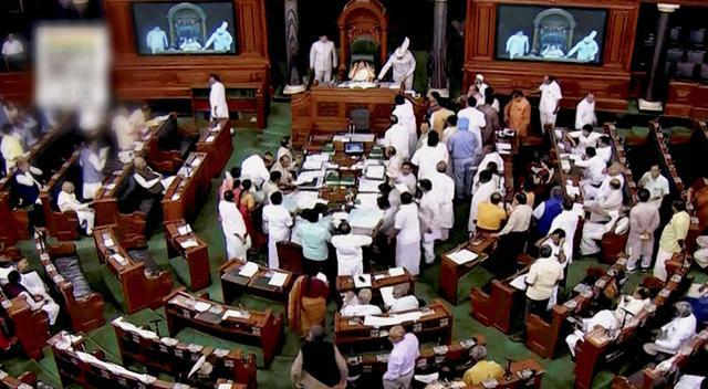 A view of the Lok Sabha as opposition members protest in the well of the House. (PTI Photo) A view of the Lok Sabha as opposition members protest in the well of the House. (PTI Photo)