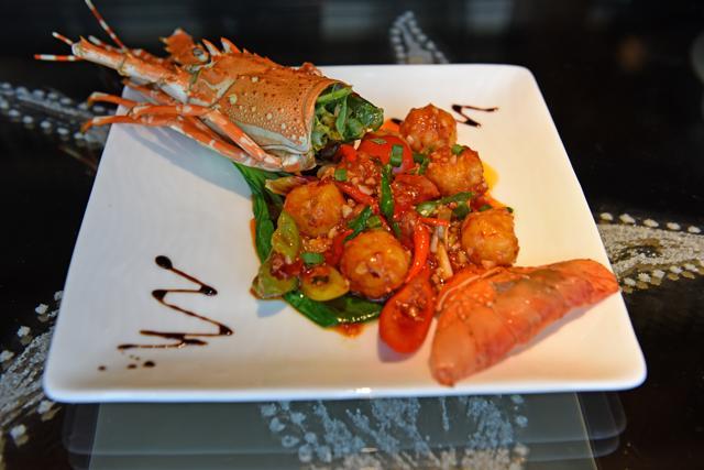 The lobster meat is cooked well too, but its Chindian chilli-garlic sauce drown out the crustacean’s flavour. (Satyabrata Tripathy / HT Photo)