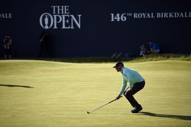 US golfer Matt Kuchar lines up a putt on the 18th green during his opening round 65 on the first day of the Open Golf Championship. (AFP)
