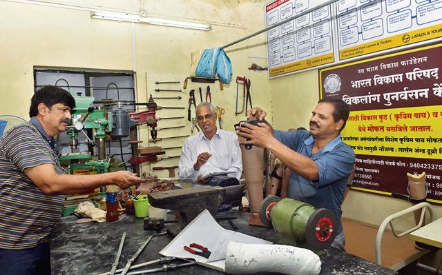 (From Left) Vinay Khatavkar, Center Head, Vasudev Kalra, center manager, Sanjay Pingale chief technician at Bharat Vikas Parishad Handicap Rehabilitation Center, Erandvane in Pune (Pratham Gokhale/HT PHOTO)