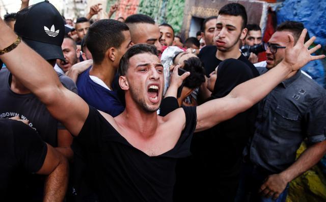 A Palestinian mourns as others behind him carry the body of Mohammed Abu Ghannam, who was shot dead during clashes with Israeli forces, during his funeral in Al-Tur area of east Jerusalem, on July 21, 2017. (AFP Photo) A Palestinian mourns as others behind him carry the body of Mohammed Abu Ghannam, who was shot dead during clashes with Israeli forces, during his funeral in Al-Tur area of east Jerusalem, on July 21, 2017. (AFP Photo)