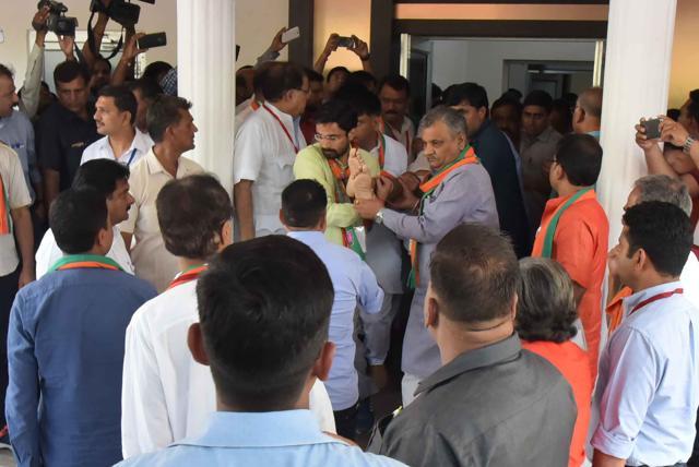 Party men carry Sanwar Lal Jat to an ambulance after he collapsed at the BJP office in Jaipur on Saturday. (Prabhakar Sharma/HT Photo) Party men carry Sanwar Lal Jat to an ambulance after he collapsed at the BJP office in Jaipur on Saturday. (Prabhakar Sharma/HT Photo)