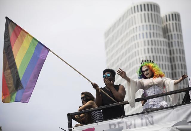 A participant waves a rainbow-coloured flag at the Christopher Street Day parade in Berlin on July 22, 2017.  (AP Photo)