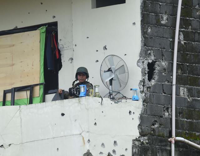 A soldier sits inside a bullet-riddled house in Marawi City in the southern island of Mindanao on July 24, 2017. The Philippine government is continuing to fight militants in the southern city as Congress voted to extend martial law over the southern Philippines until the end of the year. (AFP) A soldier sits inside a bullet-riddled house in Marawi City in the southern island of Mindanao on July 24, 2017. The Philippine government is continuing to fight militants in the southern city as Congress voted to extend martial law over the southern Philippines until the end of the year. (AFP)