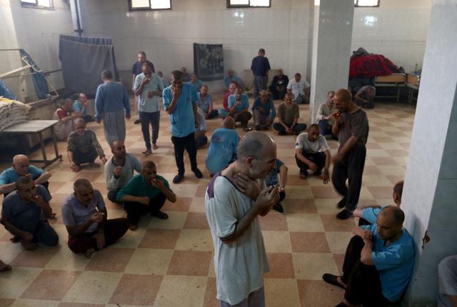 Syrian patients smoke cigarettes in a room at the mental health clinic in the town of Azaz, near the border with Turkey, on July 6, 2017. (AFP) Syrian patients smoke cigarettes in a room at the mental health clinic in the town of Azaz, near the border with Turkey, on July 6, 2017. (AFP)